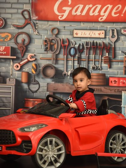 A cool and confident pose in his very own garage. This theme is great for capturing a toddler's growing independence and personality.