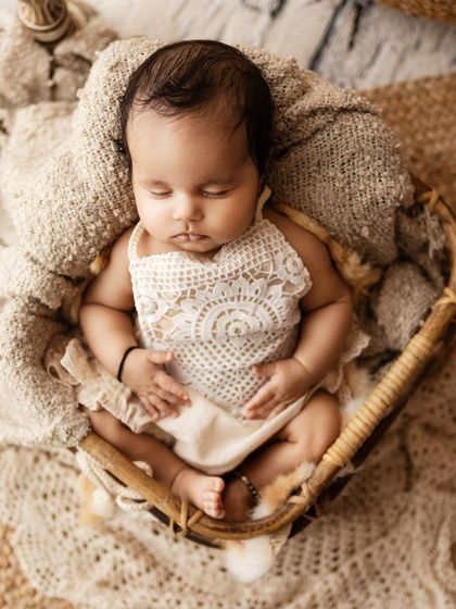 A different pose in the same session, with the baby wearing a beautiful lace outfit, showcasing the variety of props and styling I offer.