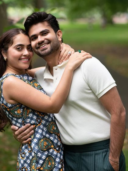 A bright and happy portrait of the couple embracing in the park. Their direct smiles to the camera make this a warm and engaging photograph from their casual London shoot.
