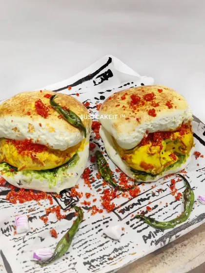 Is it a snack or is it cake? This hyper-realistic Vada Pav cake is my tribute to Mumbai's favourite street food. It's a butterscotch cake inside, designed to surprise and delight, and a perfect example of how I love to play with food themes.