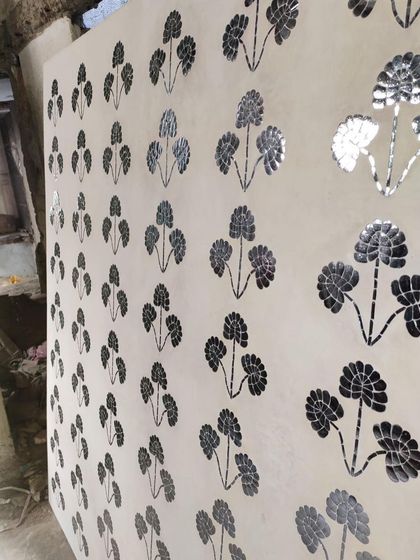 The finished Thikri panel, with hundreds of hand-cut pieces of convex glass set into plaster. This 400-year-old Rajasthani craft creates a stunning, reflective surface that plays with light.