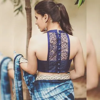 A high-neck halter blouse with a beautiful lace panel on the back. This is a great option for a modern and sophisticated look with a saree or lehenga.