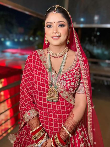 A happy bride ready for her wedding. The makeup is fresh and radiant, with a subtle smokey eye that makes her features pop.