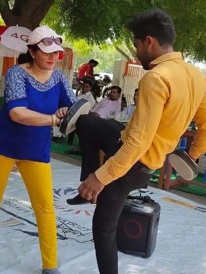 A self-defence demonstration at a government school summer camp, teaching students how to block kicks and protect themselves.
