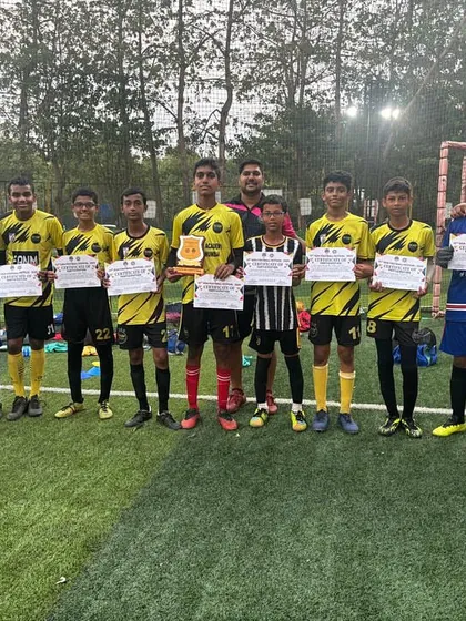 Another one of our youth teams with their coaches, holding their certificates after competing. We are proud of the effort and heart they show in every game.