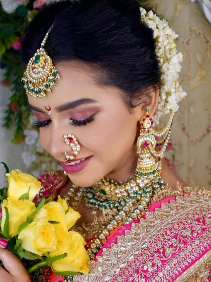 Another angle of the Maharashtrian bridal look, showing the side profile with the floral bun and detailed jhumkas.