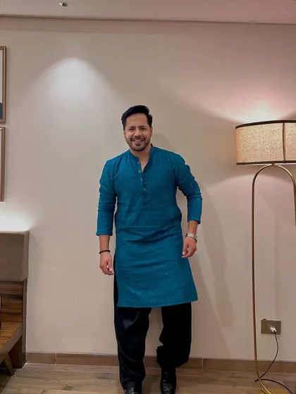 A full-length view of the teal kurta with a black salwar. A modern and stylish combination.