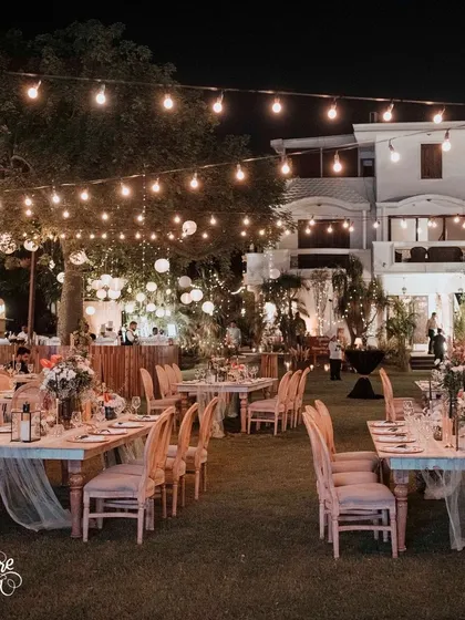 For a 50th anniversary, the theme was 'Vintage Romance'. I used strings of warm Edison bulbs to create a magical canopy over the entire garden, setting a dreamy and celebratory mood for the evening's dinner and festivities.