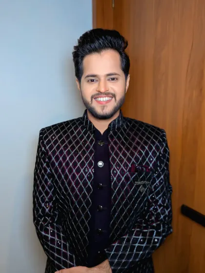 A front-facing portrait showing off the complete look. The diamond-patterned jacket is a modern choice for a fashion-forward groom.