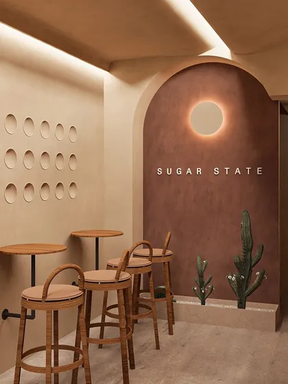 This seating nook at Sugar State Bakery embodies my love for minimalist, Wabi-Sabi design. The curved, textured walls and simple, elegant furniture create a pocket of calm for customers to enjoy their treats.