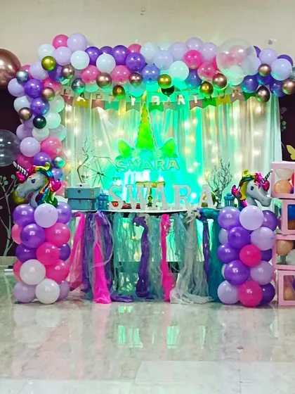 Another angle of the elaborate unicorn-themed decor for Swara's party, showing the full balloon arch and table setup.
