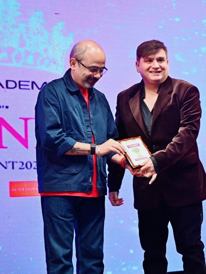 A candid moment on stage while receiving the Global Achievers Award. These honors fuel my passion for fashion and design.