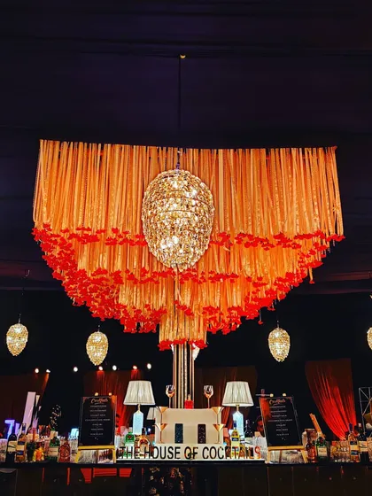 A classic and grand bar setup for a wedding reception at Bellamonde. The cascading floral and fabric decor, paired with crystal chandeliers, creates a truly romantic and luxurious atmosphere.