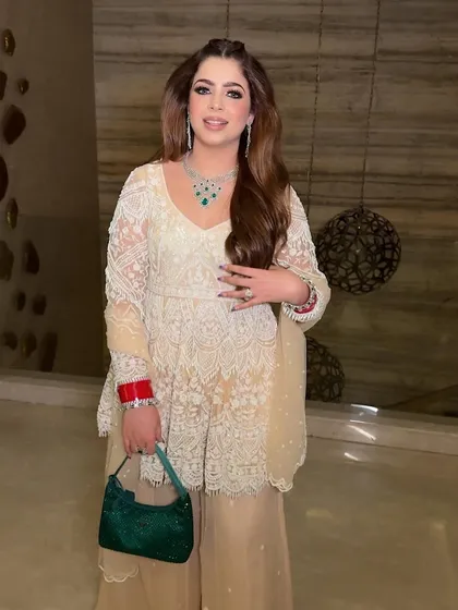 Posed and pretty. Her makeup is designed to look flawless and natural, enhancing her features without being overpowering.
