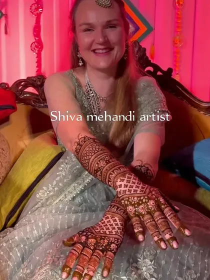 A happy client with her intricate pattern-based mehendi, showing that this classic style is loved by all.