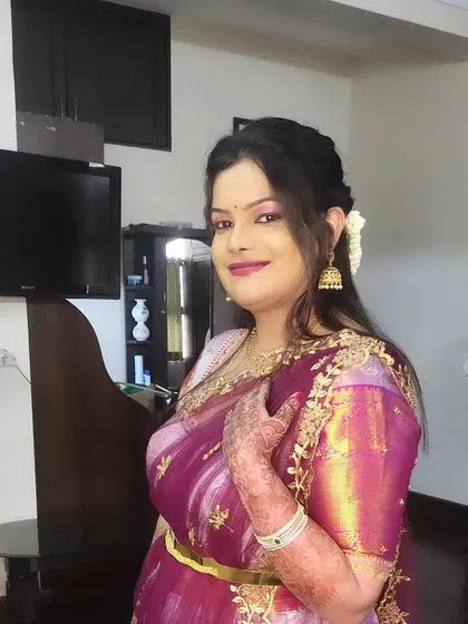 A beautiful party look for Kalyani. The pink tones in the makeup perfectly match her embroidered half-saree style outfit.