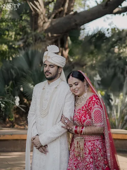 A gentle, quiet portrait of the couple on their wedding day. The bride rests her head on the groom's shoulder, a simple pose that speaks volumes.
