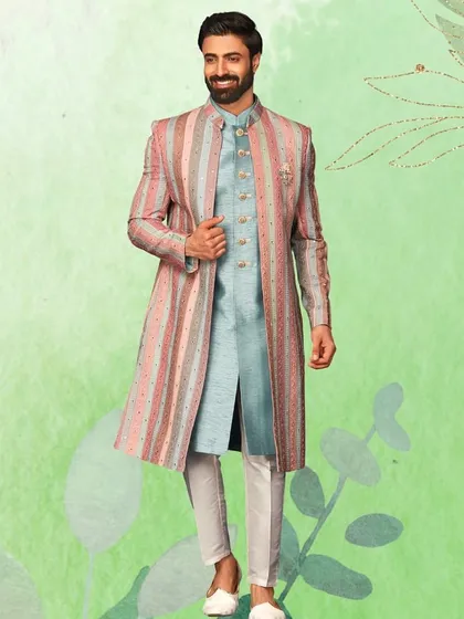 For a truly contemporary vibe, this striped pastel sherwani is an excellent choice. The blend of pink, blue, and grey is modern, fresh, and perfect for a spring or summer wedding.