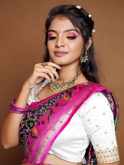 A modern twist on a traditional look, this model pairs our kundan and green bead choker with a unique saree drape.