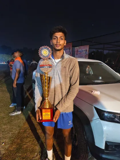 A player holding the runner-up trophy after a hard-fought tournament. Even in defeat, we show pride in our effort and learn for the next battle.