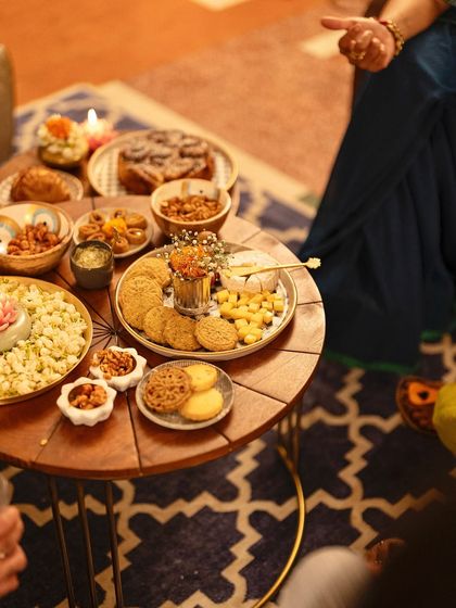 A cozy, intimate grazing table set up for a Diwali party. Our savory shortbreads, cheese platters, and other bites are perfect for guests to mingle and enjoy.