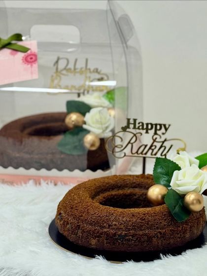 For the health-conscious sibling, I offer this wholesome cake made with whole wheat and jaggery. It’s beautifully decorated with sugar flowers and golden accents, proving that thoughtful treats can also be delicious.