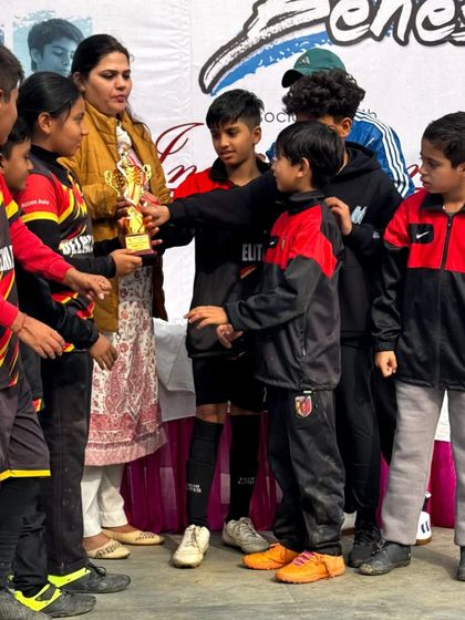 Our U-10 players receiving their runners-up trophy. We celebrate every achievement, learning from both wins and losses.