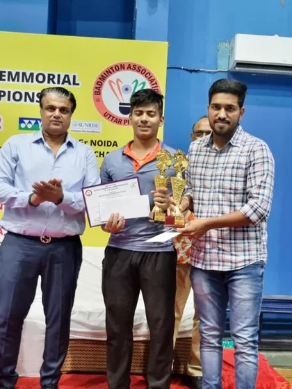 Our coach presenting the Men's Doubles trophy to the winners of the Gautumbudh Nagar District Championship. A proud moment for the academy's senior players.