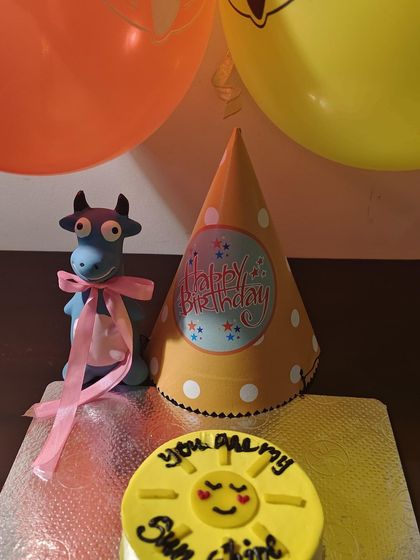 A full view of the "You Are My Sunshine" cake setup. The bright yellow color comes from natural turmeric.