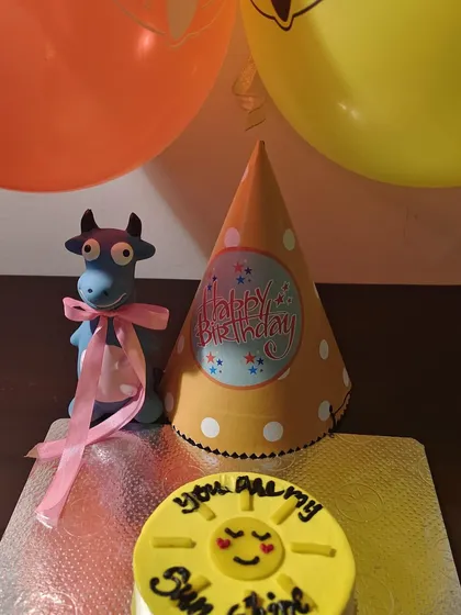 A full view of the "You Are My Sunshine" cake setup. The bright yellow color comes from natural turmeric.