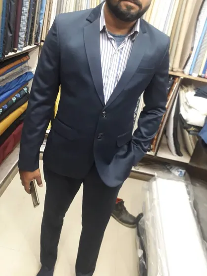 A client looking sharp in a classic dark navy two piece suit. This is one of the most requested styles, perfect for any formal or professional setting.