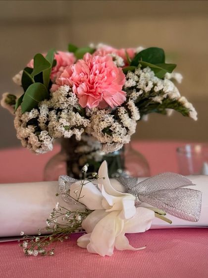 Even the smallest details are thoughtfully styled. For this Roka, each table setting included a small, fresh floral arrangement and a decorative scroll, adding a personal touch for every guest.