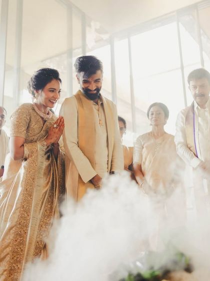 A candid moment from a housewarming ceremony. The makeup is designed to look soft and natural, capturing the warmth and joy of the occasion.