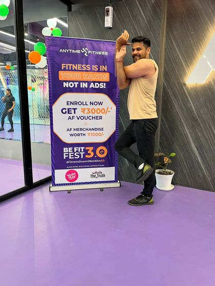 A member confidently holds the Eagle Pose, showcasing the progress that can be made with regular attendance.