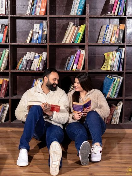 A sweet shot of a couple reading together in our library set. This captures a shared interest and creates a warm, narrative-driven pre-wedding photograph.