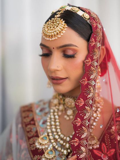 A softer profile, showing the blend of the eyeshadow and the flawless skin finish. The makeup looks perfect from every angle.