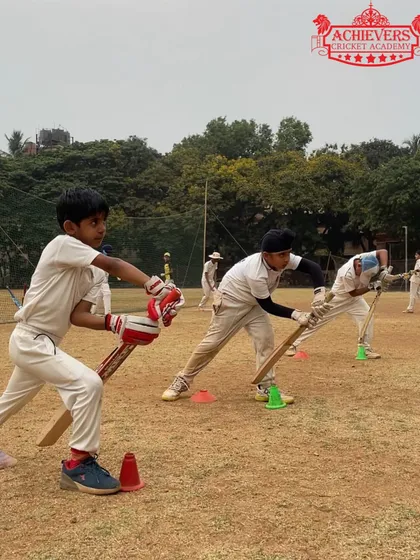 Young players practicing their batting stance on the first day of summer camp. The energy and enthusiasm are contagious.