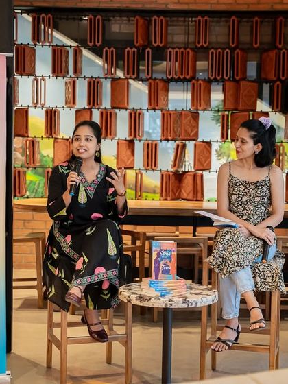 A full view of the stage setup for Stuti Changle's book launch, showing our branding alongside the author's promotional material for a professional look.