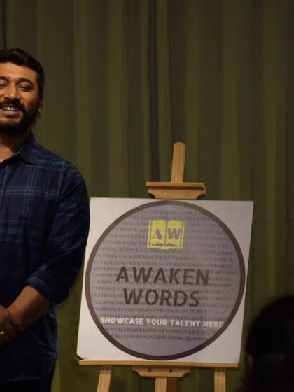 The full stage view of a performer at the "Awaken Words" open mic.