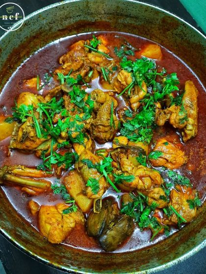 A pot of my home-style chicken curry, garnished generously with fresh coriander. Simple, authentic, and delicious.