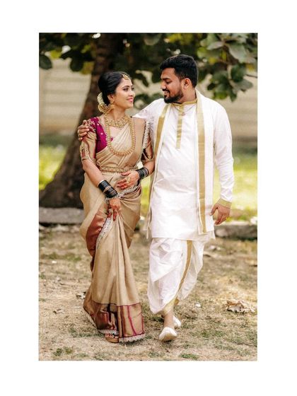 A couple in traditional attire walking together, a classic and elegant wedding portrait.
