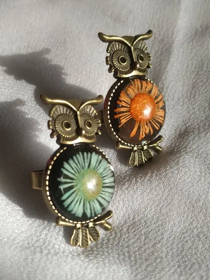 Here are two of my good luck owl rings, one with an orange flower and one with a light blue one. They make a wonderful and meaningful gift, and the adjustable band ensures a perfect fit.