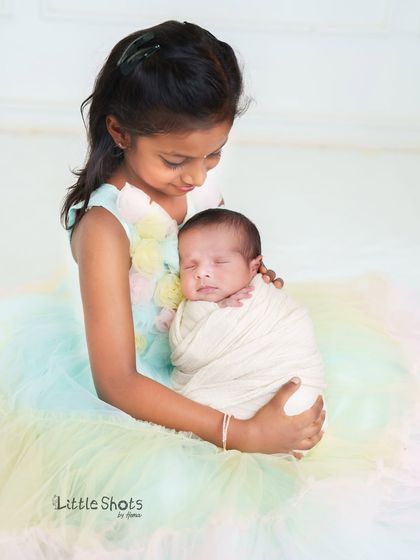 A big sister's loving gaze. Capturing the first moments between siblings is one of my greatest joys. I create a safe and comfortable space for these precious introductions.