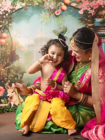 A candid moment of pure delight. The playful expressions captured during our Janmashtami shoots are what make these memories so precious and full of life.