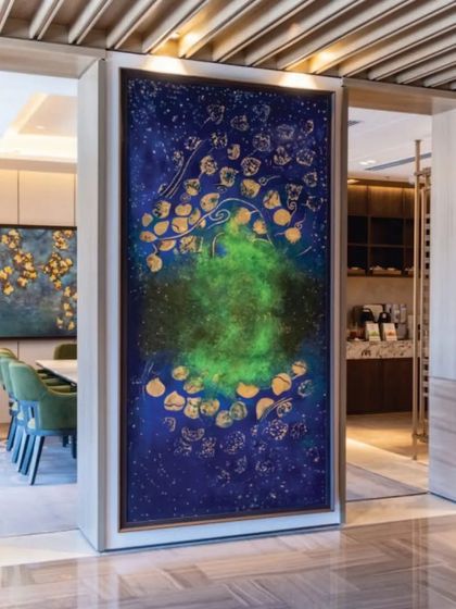 The 'Aurora Borealis' painting creating a focal point in a lounge at JW Marriott. The artwork's cosmic theme and vibrant colors are chosen to complement the hotel's modern and luxurious interior design.