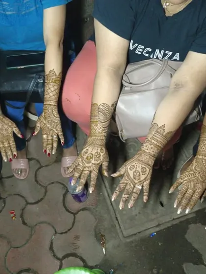 A group of friends showing off their matching mehendi designs. This is a fun idea for a bridal party or a group of friends celebrating a festival together.