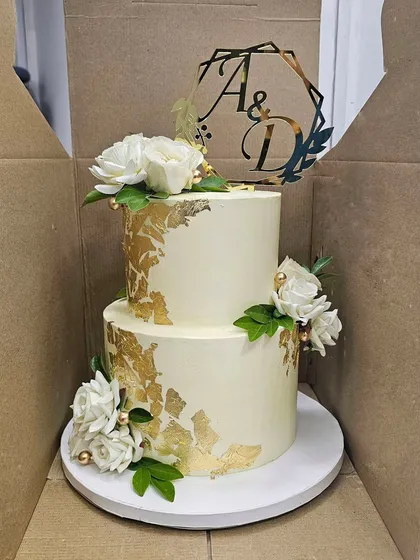 The two-tier white and gold cake, ready for delivery in its custom box. I ensure every cake is transported safely to the venue.