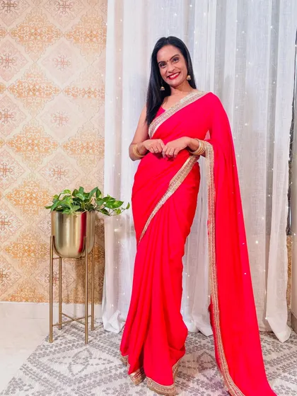 Another beautiful red saree, this one in a flowy georgette with a delicate gold border. It's a versatile and elegant choice for any festive occasion.