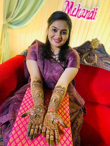 A beautiful photo of a bride with her completed mehndi, ready for her wedding festivities. The design is traditional, intricate, and perfectly applied.