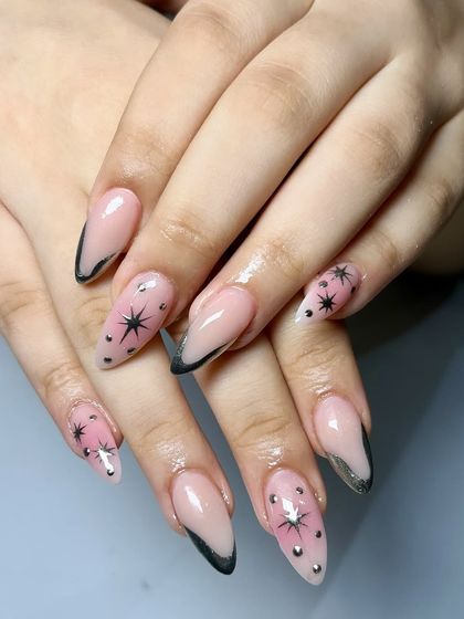 An example of our new chrome designs. This set features a sheer pink base with black chrome tips and celestial star details for a dreamy, gothic look.